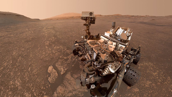 Curiosity rover is moving on Martian terrain.